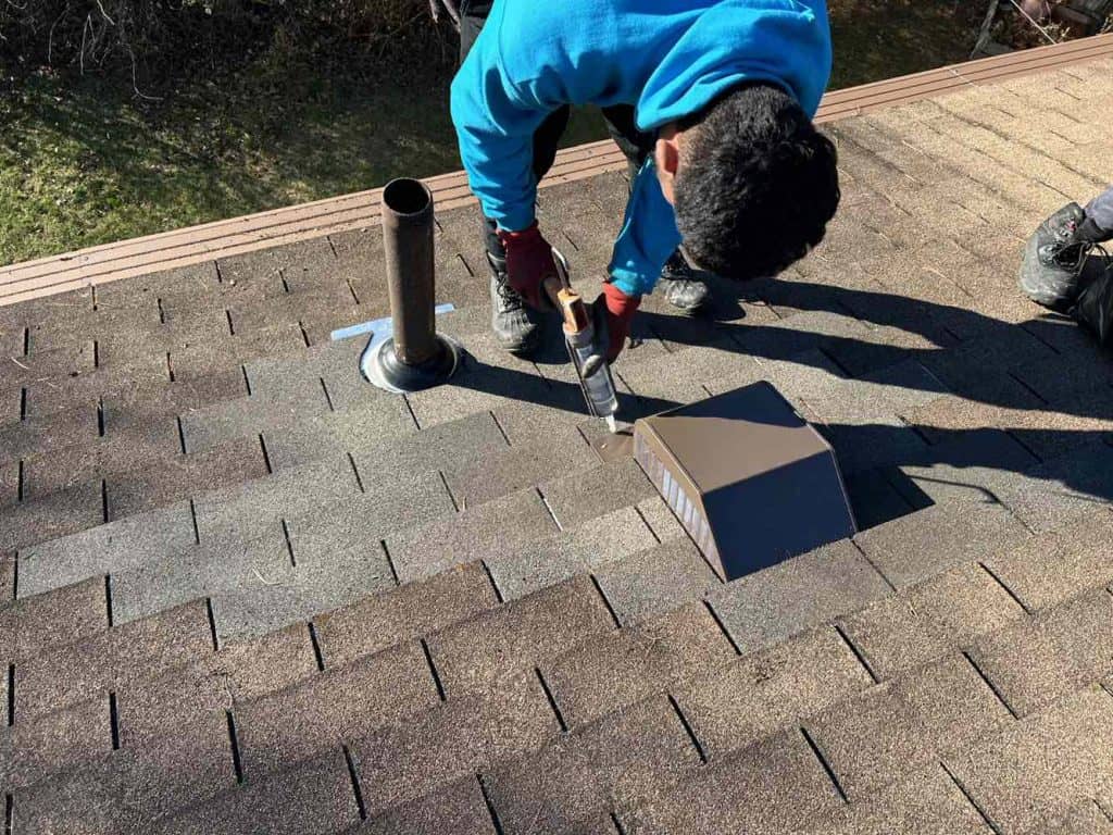 A Surf & Turf Roofing professional works on a roof repair job