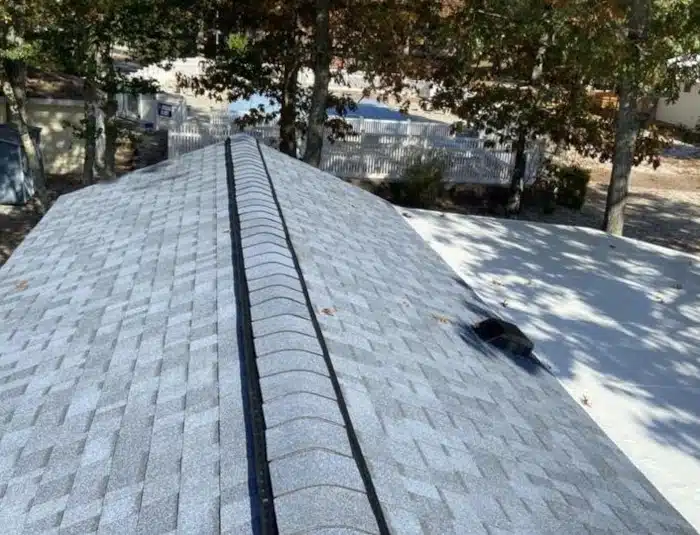 A newly replaced double wide mobile home roof with asphalt shingles, showcasing the results of investing in an affordable and durable double wide mobile home roof replacement cost.